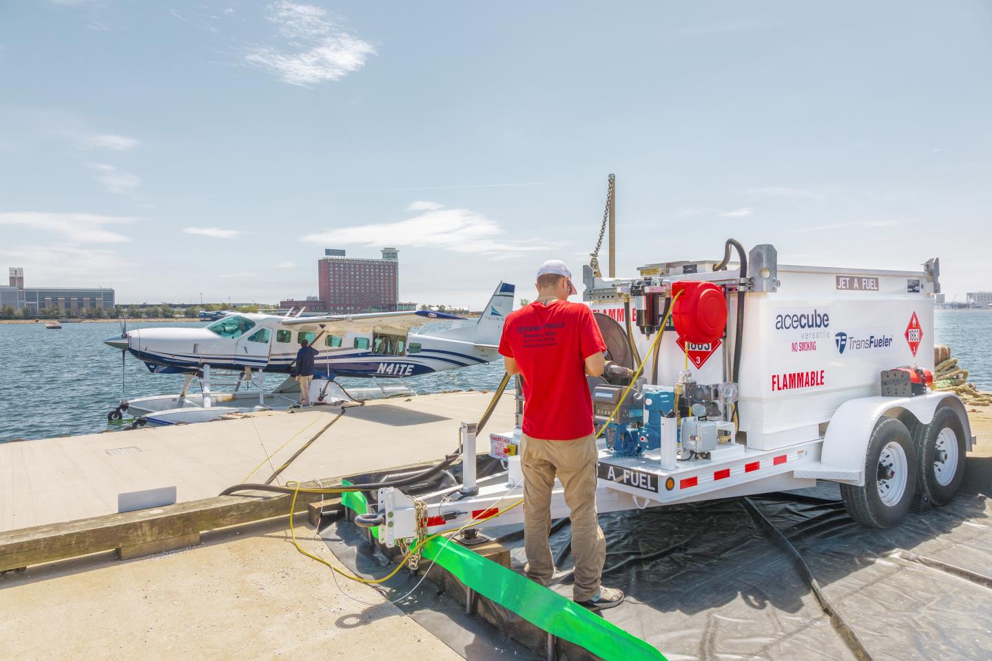 A sea plane being refueled at by a Harbor Fuels staff member